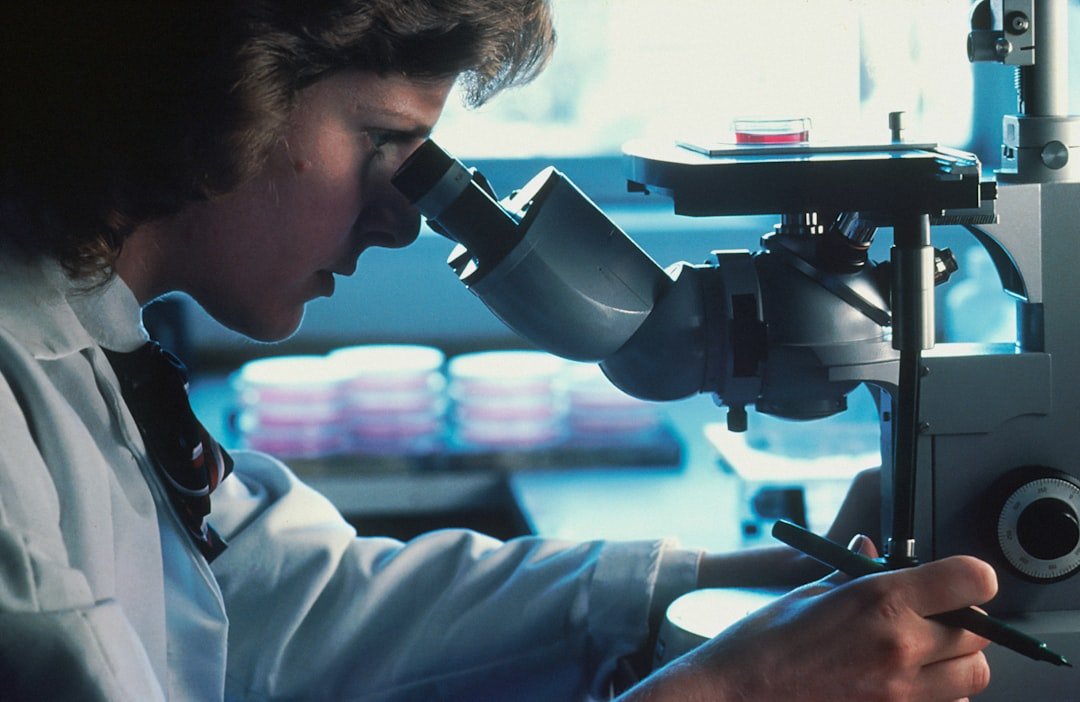 Scientist at microscope representing Besremi evidence review